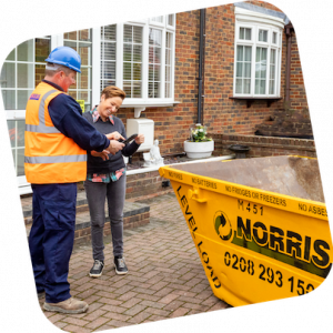 A Norris skip being delivered to a customer by a friendly truck driver.