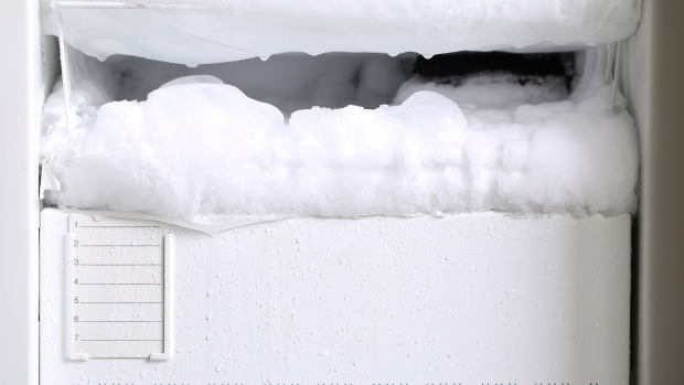 A freezer that needs thawing as it's covered in ice.